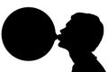 Silhouette of teenage boy blowing huge bubble