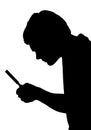 Silhouette of teenage boy investigating with a magnifying glass