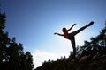 Silhouette Of Teenage Girl Balancing On Rock