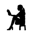 silhouette of a female teen reading a book.