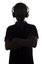 Silhouette of teenager listening to music in headphones, guy folded his arms on the chest on white isolated background, concept