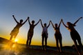 Silhouette of teens at sunset on the beach, happiness concept Royalty Free Stock Photo