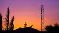 Silhouette of telecommunication antenna cellular tower for telephony with beautiful sunset