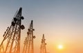 Silhouette, telecommunication towers with TV antennas and satellite dish in sunset Royalty Free Stock Photo