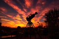 silhouette of telescope setup during sunset
