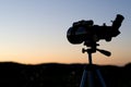 Silhouette of a Telescope at Sunset