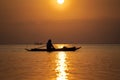 Silhouette of thai man in a boat during sunset at sea water near tropical island Koh Phangan, Thailand