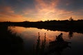 Silhouette of thoughtful man on river dramatic sunset sky Royalty Free Stock Photo