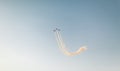 Silhouette of three airplanes performing acrobatic stunt flight on blue sky - Trace of Smoke behind