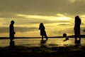 Silhouette three boys plays beach ball and moment the ball falling during sunset sunrise