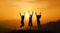 Silhouette of three girls jumping in the air on a mountain above the clouds at sunset or sunrise Royalty Free Stock Photo