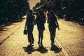 Silhouette of three girls of women walking in the center