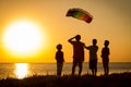 Kids launching the rainbow kite together Royalty Free Stock Photo