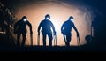Silhouette of Three Miners with Headlamps Working Together Deep Underground in a Coal Mine Royalty Free Stock Photo