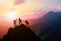 Silhouette three people helping each other hike up a mountain at sunrise or sunset. Giving a helping hand. Travel hiking journey Royalty Free Stock Photo