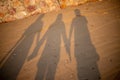 Silhouette of three people on the sand Royalty Free Stock Photo