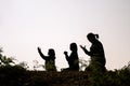 Silhouette of three woman kneeling down praying for worship God at white background. Christians pray to jesus christ for calmness Royalty Free Stock Photo