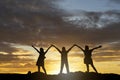 Silhouette Three young people standing on sunset background