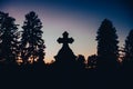 Silhouette of tombstone cross at evening Royalty Free Stock Photo