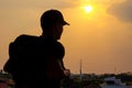 Silhouette of a tourist backpacking a man wearing a cap is going out to the world Royalty Free Stock Photo