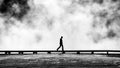 Silhouette of tourist on a footbridge.