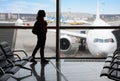 Silhouette of a tourist girl in the airport terminal