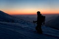 silhouette of tourist man on a snowy mountain against the background of the sky and sunset Royalty Free Stock Photo