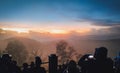 Silhouette of tourists enjoying and recording the sunrise from Penanjakan Hill, Bromo Tengger Semeru National Park, Indonesia.