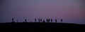 Silhouette tourists on Etna Volcano at sunset light