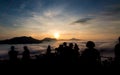 Silhouette of tourists looking at mist and mountain with blue sky in nature landscape