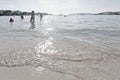 Silhouette tourists play on the beach