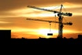 Silhouette of Tower crane on a construction site on sunset background Royalty Free Stock Photo