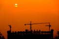 Silhouette of tower crane on construction site at sunset Royalty Free Stock Photo
