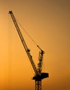 Silhouette of tower crane for construction site at sunset Royalty Free Stock Photo