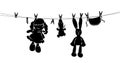 Silhouette toys drying on rope after washing