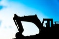 silhouette tracked excavator Sand and stone And sky background Royalty Free Stock Photo