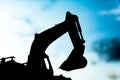 silhouette tracked excavator Sand and stone And sky background Royalty Free Stock Photo