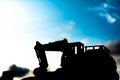 silhouette tracked excavator Sand and stone And sky background Royalty Free Stock Photo