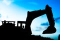 silhouette tracked excavator Sand and stone And sky background Royalty Free Stock Photo