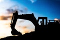 silhouette tracked excavator Sand and stone And sky background Royalty Free Stock Photo