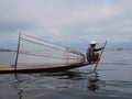 Silhouette of traditional fisherman with large conical net on Inle Lake Myanmar