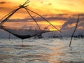 Silhouette of traditional fishing method using a bamboo square dip net with sunrise sky background Royalty Free Stock Photo