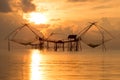 Silhouette traditional horse asia fishing net on sunrise.