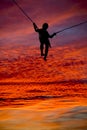 Silhouette trampolining boy gorgeous sunset Royalty Free Stock Photo