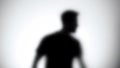 Silhouette of trapped man standing behind glass wall, room escape, close-up Royalty Free Stock Photo