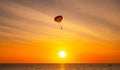 Silhouette Travel people Parasailing over sea Against sky during sunset in golden hour of sunset or sunrise sky,Active and extreme Royalty Free Stock Photo