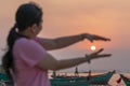 Silhouette of traveler Asian woman watching the sunset