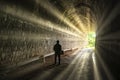 Silhouette traveler man explored in the ancient railway tunnel,