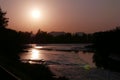 Silhouette of tree, mountain and river at sunset Royalty Free Stock Photo