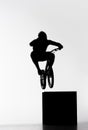 silhouette of trial biker jumping on cube Royalty Free Stock Photo